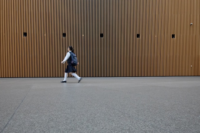 A kid walking to school in comfortable shoes from The Foot Spot.
