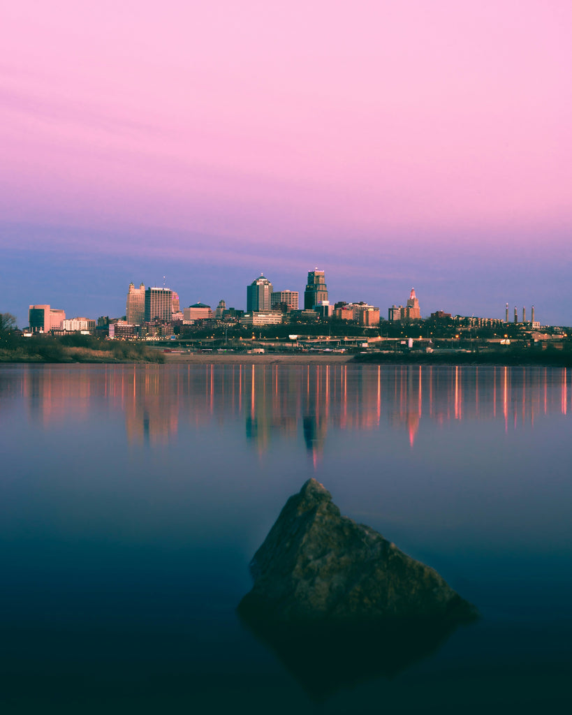 Need a comfort shoe store? Head to The Foot Spot, with two locations in Kansas City. The picture shows a sunrise over Kansas City and the Missouri River. Photo by Jake Fagan from Unsplash.